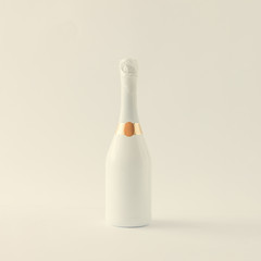 Minimalistic white champagne bottle on white background. Party concept.