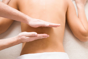 Masseur hands doing massage on young woman back in the spa beauty salon. Enjoying life. Relaxing day. Body care concept.