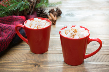 Red cup of hot chocolate with marshmallow on windowsill. Weekend concept. Home style. Christmas time.