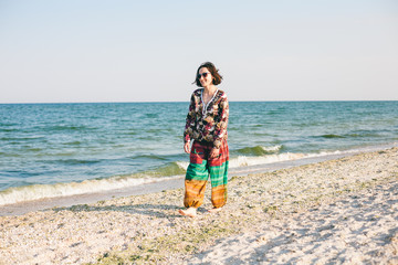 A girl is walking along the beach.