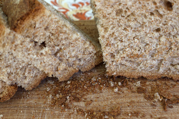Closeup of whole grain bread cut on a breadboard