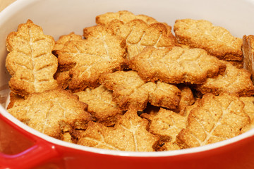 Closeup heap of homemade crunchy cookies in the form of leaves. Shallow focus. Food background.