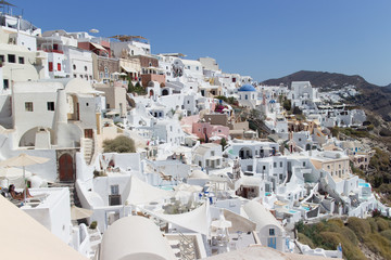 Fototapeta na wymiar Landscape panorama with white houses and ancient wind mill in the Oia, Greece