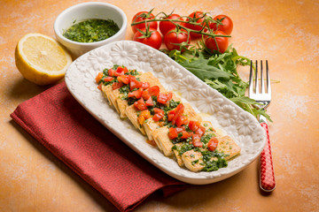 tofu salad with tomatoes marinated with arugula pesto and lemon
