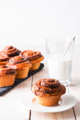 Fresh bread with cinnamon and a glass of milk.