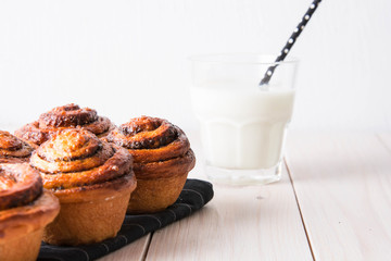 Fresh bread with cinnamon and a glass of milk.