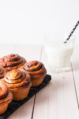 Fresh bread with cinnamon and a glass of milk.