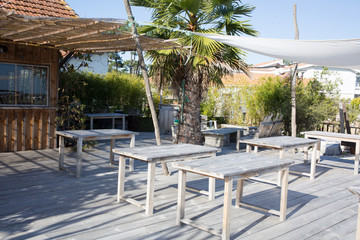 Summer empty open air restaraunt near sea at exotic island on beautiful sunset