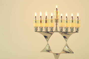 image of jewish holiday Hanukkah background with menorah (traditional candelabra) and candles.