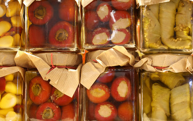 jars of Italian products preserved in oil with green peppers gar
