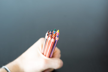 Colored pencils in hand