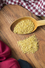 Wooden Spoon Filled With Cracked Wheat (Bulgur)