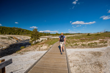 Tourist with backpack hiking in Yellowstone