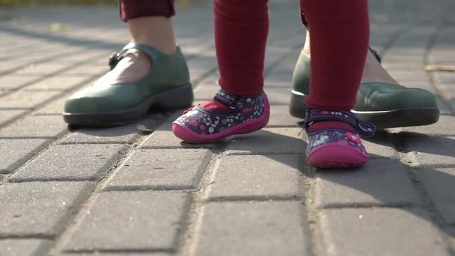 Slow Motion Mom And Baby Gerl Walk Along The Path