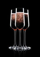 Rose pink champagne glasses with bubbles isolated