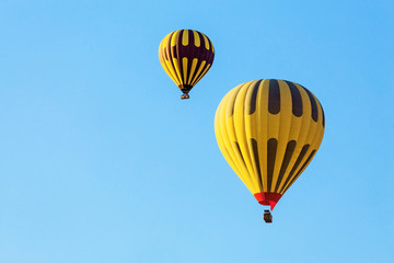 Fototapeta premium Many unrecognizable colorful hot air balloons against blue sky