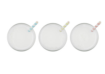 Glasses of fresh milk with straw top view