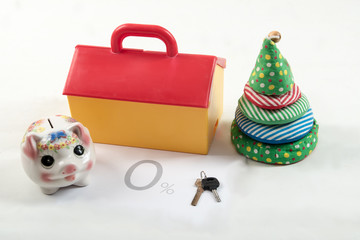 Interest-free loan. Piggy Bank. The concept of thrift and savings on housing. The key, a toy house, Christmas.
