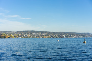 Fototapeta na wymiar lake zurich water view with gold coast in the back and mountains