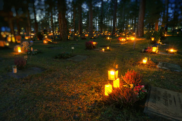 Candlelights at the graves at the Woodland cemetary or Skogskyrkogarden during All saints night