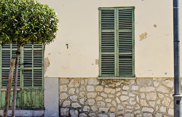 Fototapeta na wymiar Painted doors and windows houses on the main street in , Majorca, Spain