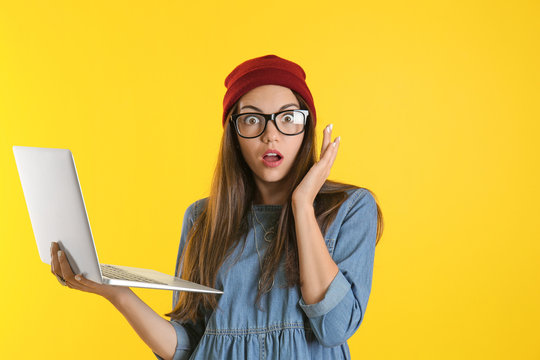 Young Woman With Laptop On Color Background. Internet Shopping Concept