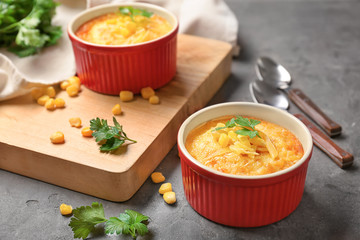 Ramekins with corn pudding on table