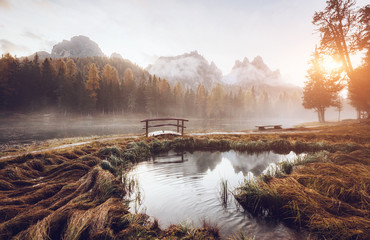 Great view of the foggy lake Antorno in National Park Tre Cime di Lavaredo.