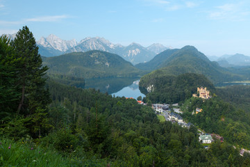 Naklejka na ściany i meble Castle Schwangau with green pine forest and lake
