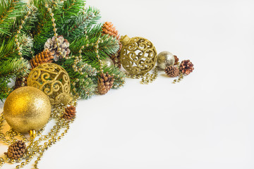 Christmas and New Year's background. A branch of a Christmas fir-tree with garlands, gifts, spheres, toys and decorating for a Christmas tree.