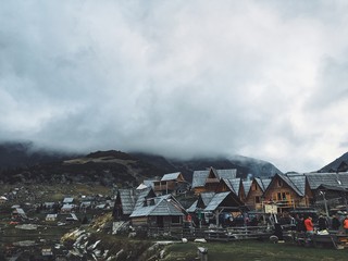 Fototapeta premium misty mountains over village on cold autumn day