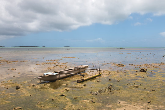 Abandoned old outrigger canoe on shallow water, Tongatapu Island, Tonga
