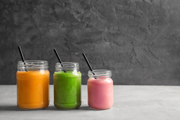 Jars with yummy smoothie on table