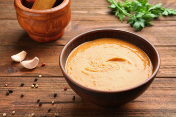 Bowl with homemade lentils cream soup on table