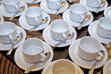 cup and spoon setting on white saucer