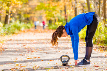 Woman outside with kettlebell