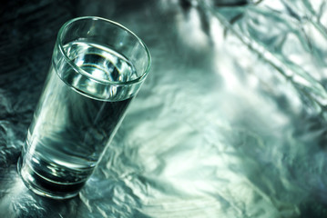 Glass of water with abstract background