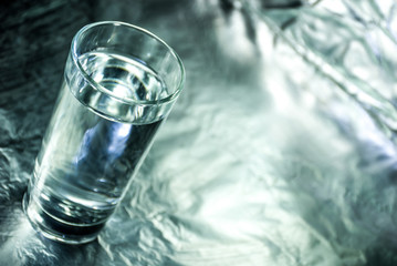 Glass of water with abstract background