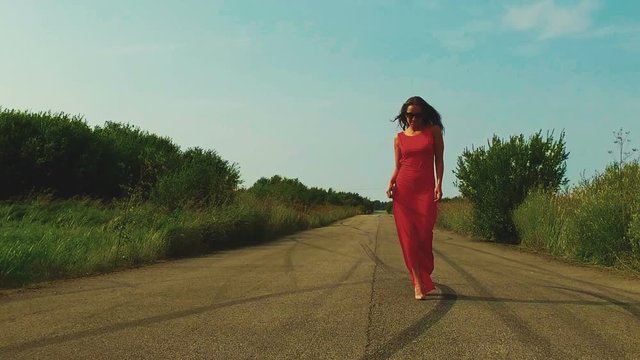 Dancing young woman in red dress