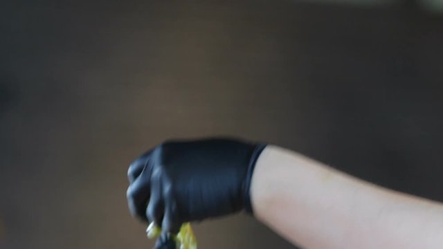 woman cooking candy on a stick from caramel