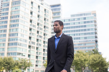 Fototapeta premium Good looking African American business man in suits, commuting on foot