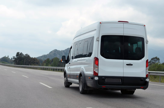 minibus in motion on a background of mountains
