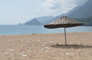 knitted umbrella on the sea beach