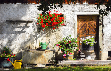 Old farm house facade with flowers in Seegraben, Switzerland.
