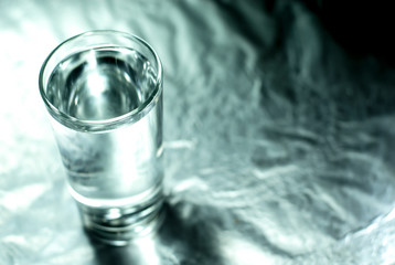 Glass of water with silver background