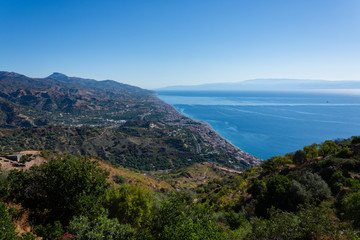 Fototapeta na wymiar panorama of the coast of Ionian sea from Forza D'Agrò village in Sicily in summer day