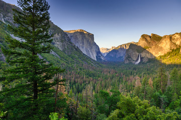 View of Yosemite Valley from Tunnel View point at sunset - view to Bridal veil falls, El Capitan and Half Dome - Yosemite National Park in California, USA