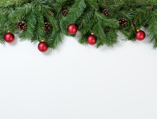 Christmas red ornaments hanging in fir tree branches