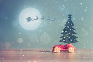 Toy Car with Christmas tree and gift box. Christmas landscape with gifts and snow. Merry christmas and happy new year greeting card with copy-space. Christmas celebration holiday background.