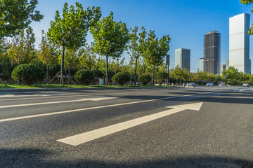 empty road and modern office block buildings against sky, china.